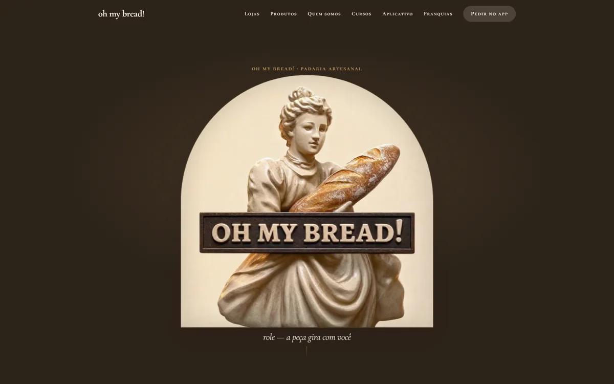 Site da oh my bread!: estátua segurando um pão sob um arco, letreiro em bronze